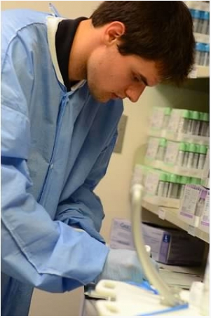 Student in Project SEARCH working in a healthcare laboratory.  