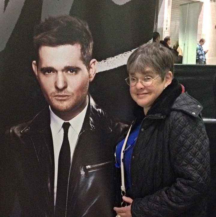 Debbie Kolesar poses with a picture of singer Michael Buble.
