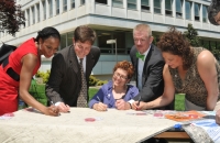 NCCDD Staff signs the ADA quilt to commemorate the ADA anniversary